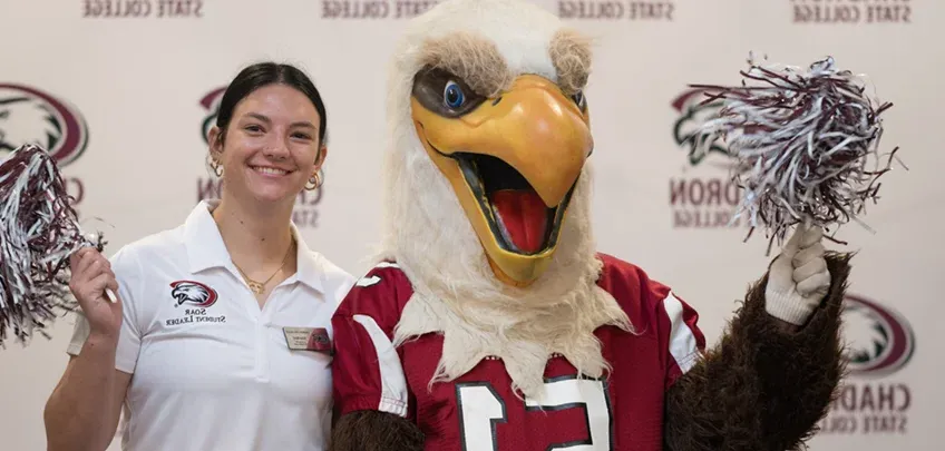 Eagle mascot and student posing for a photo